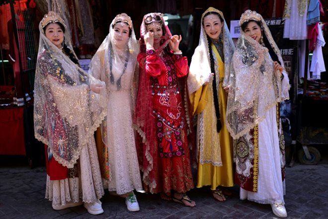 Des femmes portant des costumes traditionnels ouïghours, à Kachgar, dans le Xinjiang, le 13 juillet 2023