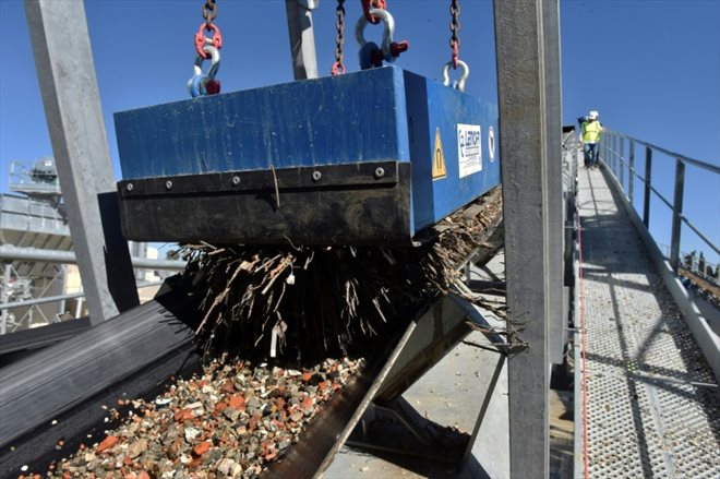 Un aimant géant extrait les morceaux de métal de graviers circulant sur un convoyeur à bande à l'usine Recycat66 de l'entreprise familiale Vaills, le 3 mai 2023 à Baho, dans les Pyrénées-Orientales