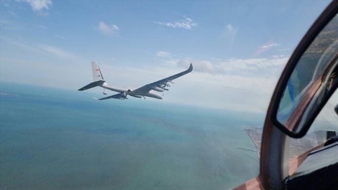 Un drone turc Akinci escorte un jet Mikoyan MiG-29 piloté par Selcuk Bayraktar, gendre du président turc Erdogan et directeur technique de la société Baykar, le 24 mai 2022 à Bakou, en Azerbaïdjan